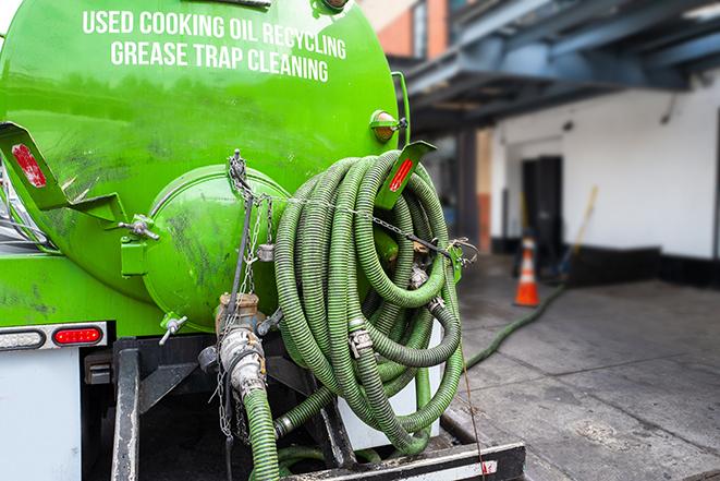 a grease trap being pumped by a sanitation technician in Blasdell NY