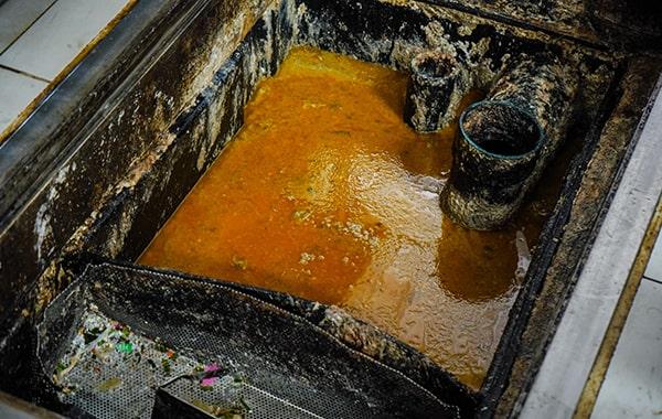 procrastinating on grease trap cleaning can result in clogs, foul odors, and even fines from local authorities